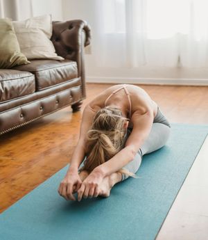 An empty, serene room with a yoga mat on the floor.