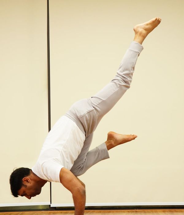 Person in a dynamic yoga pose showing strength and balance.